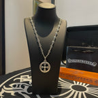Silver-tone pendant necklace with round medallion on a long chain