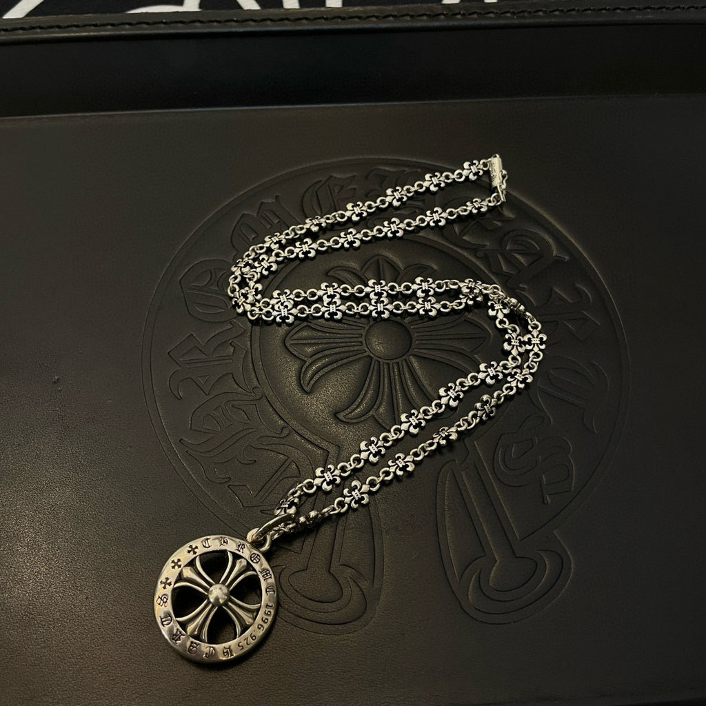 Silver-tone round medallion pendant necklace on a long chain