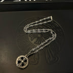 Silver-tone round medallion pendant necklace on a long chain