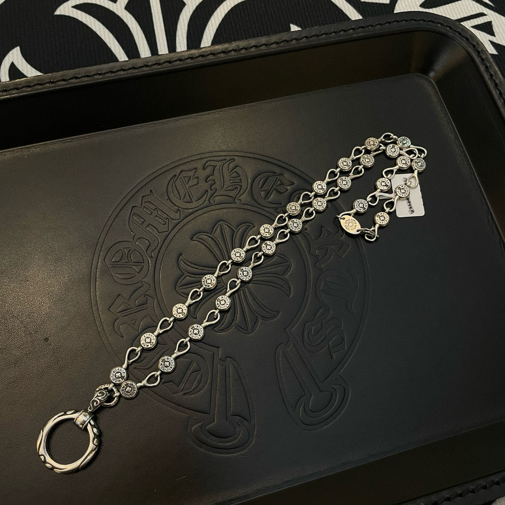 Silver-tone chain bracelet with repeating coin charms and ring-style clasp