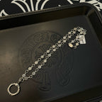 Silver-tone chain bracelet with repeating coin charms and ring-style clasp