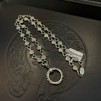 Silver-tone chain bracelet with repeating coin charms and large ring clasp