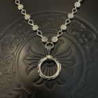 Silver-tone coin charm necklace with central ring pendant on embossed leather
