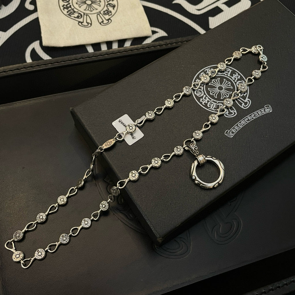 Silver-tone chain bracelet with repeating coin charms and ring-shaped clasp