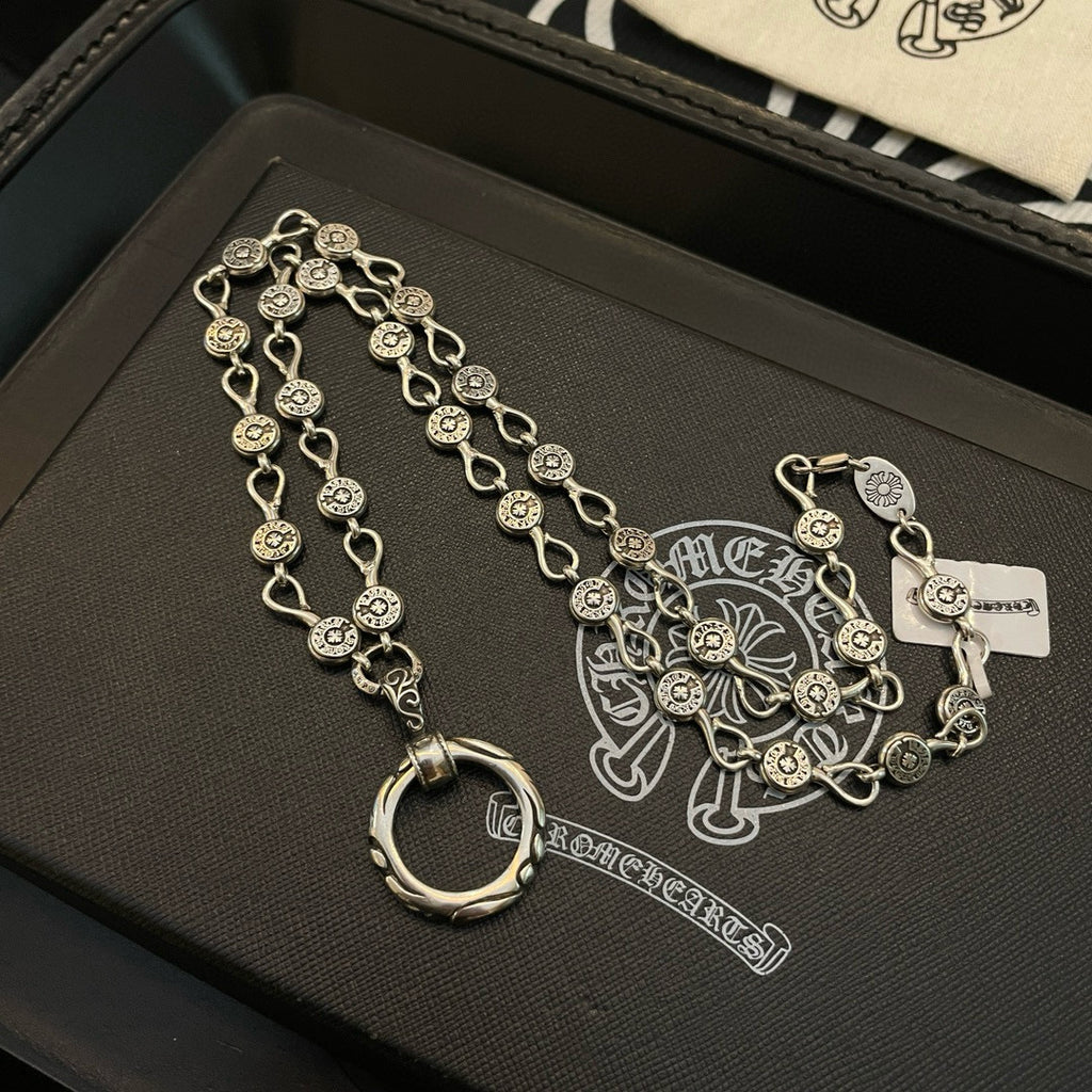 Silver-tone chain bracelet with repeating coin charms and ring pendant
