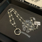 Silver-tone chain bracelet with repeating coin charms and ring pendant
