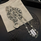Silver-tone chain bracelet with repeating coin charms and ring clasp