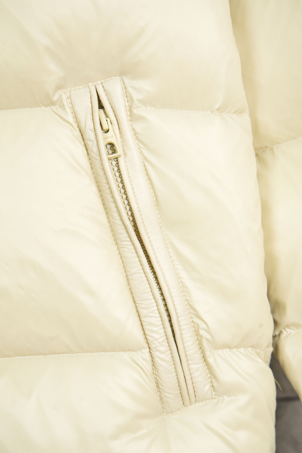 Cream puffer jacket front zipper with stitched channel detail
