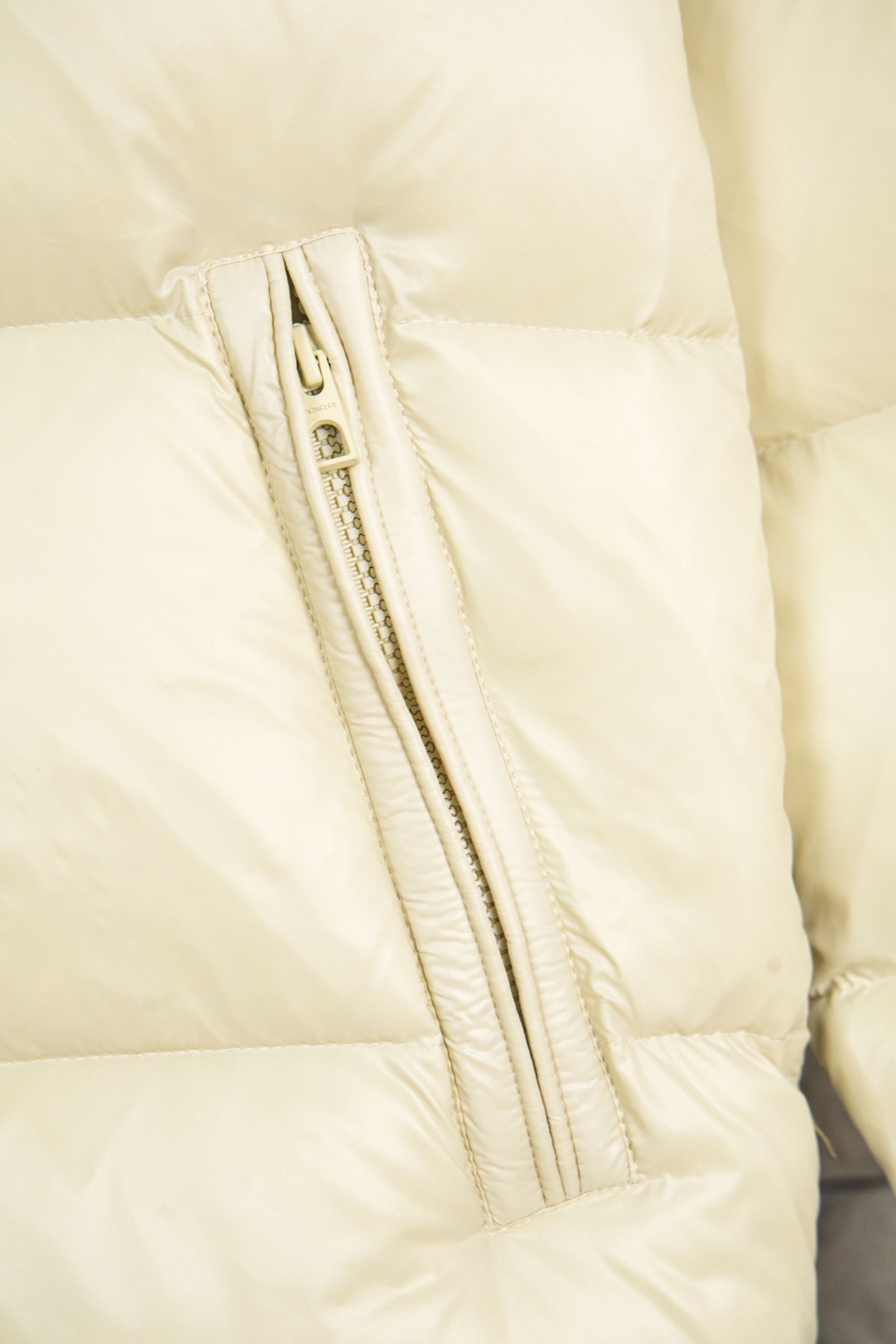 Cream puffer jacket front zipper with stitched channel detail