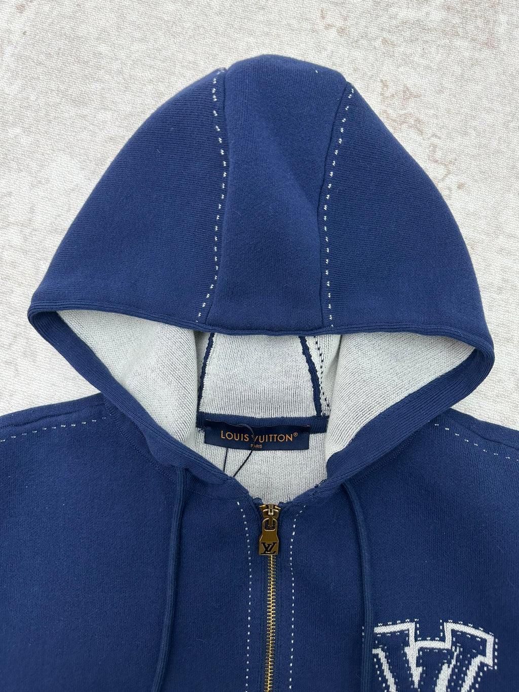 Louis Vuitton blue zip-up hoodie hood detail with light lining and gold zipper pull