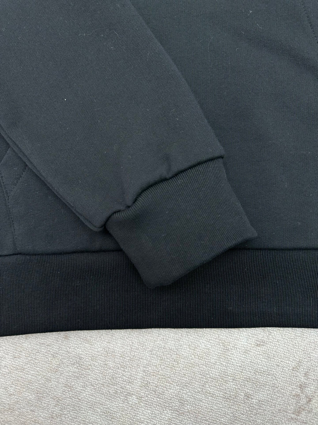 Louis Vuitton black hoodie sleeve cuff and ribbed hem detail
