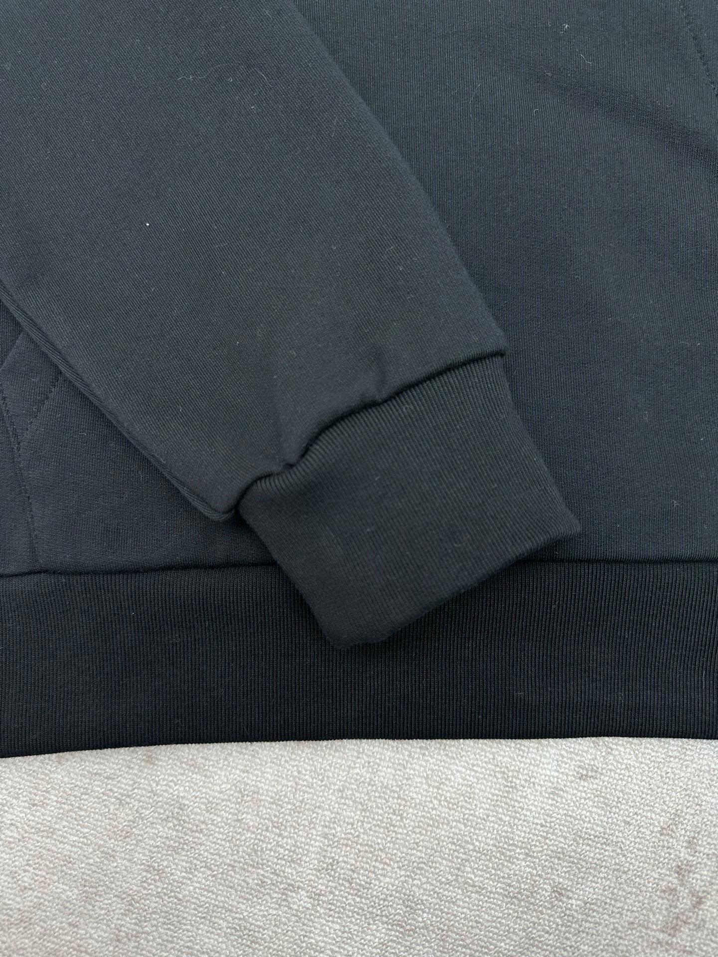 Louis Vuitton black hoodie sleeve cuff and ribbed hem detail