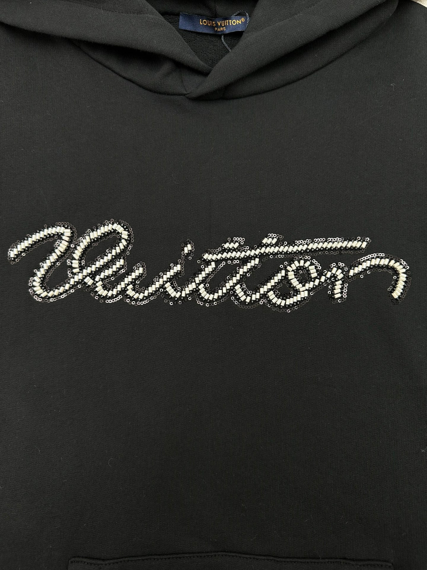Louis Vuitton black hoodie with rhinestone-style script logo across chest
