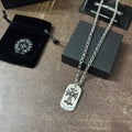 Chrome accessories necklace with silver dog-tag pendant and fleur-de-lis emblem