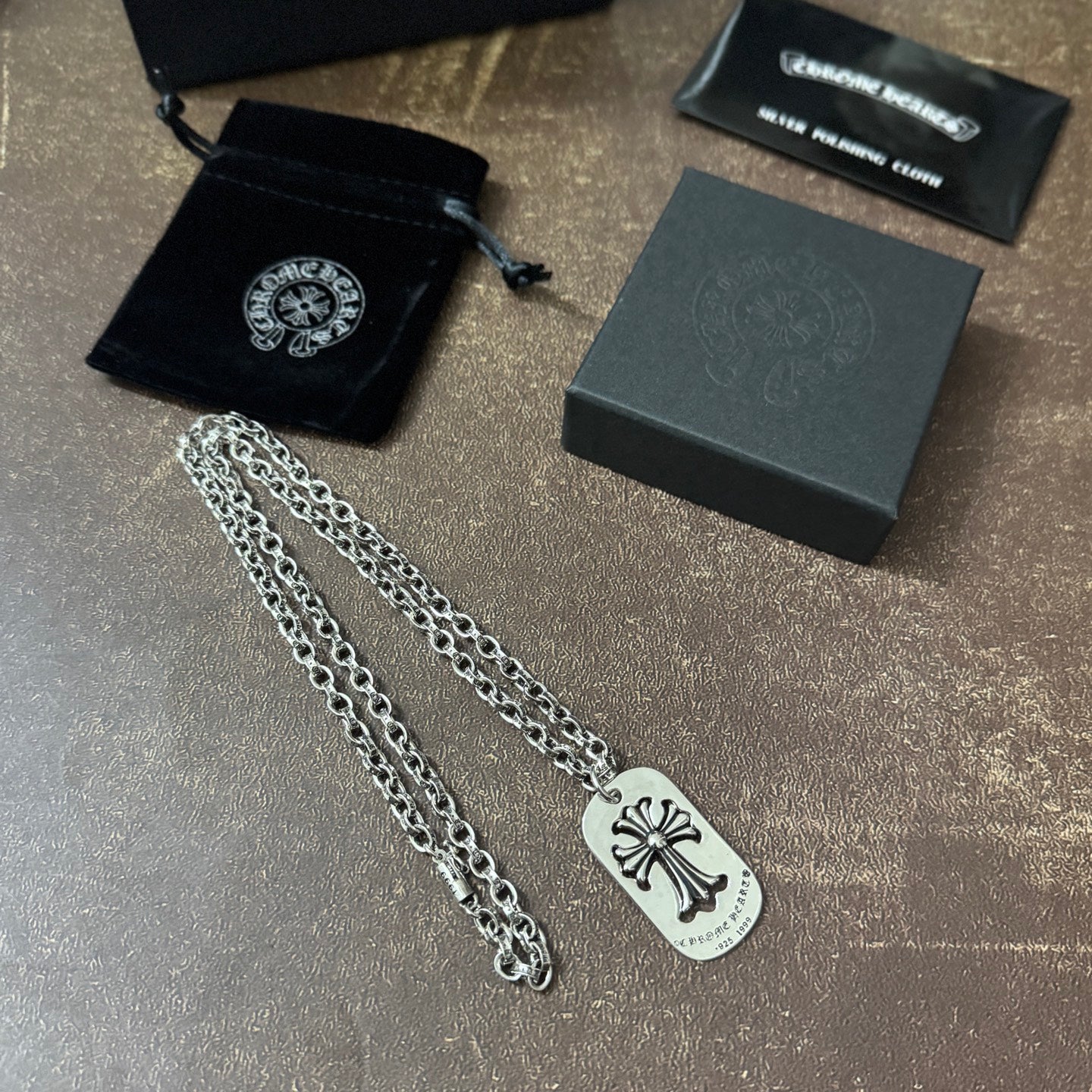 Chrome accessories necklace pair with silver chains and fleur-de-lis dog-tag pendants