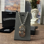 Chrome accessories necklace on black box: silver chain with fleur-de-lis dog-tag pendant