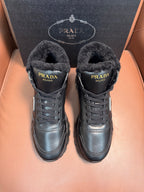Prada lace-up winter boots with dark faux-fur lining and metal logo patch