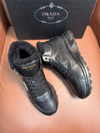 Prada lace-up boots in dark leather with faux-fur collar and chunky lug sole