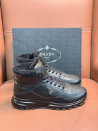 Prada lace-up boots with dark leather and faux-fur collar, shown as a pair