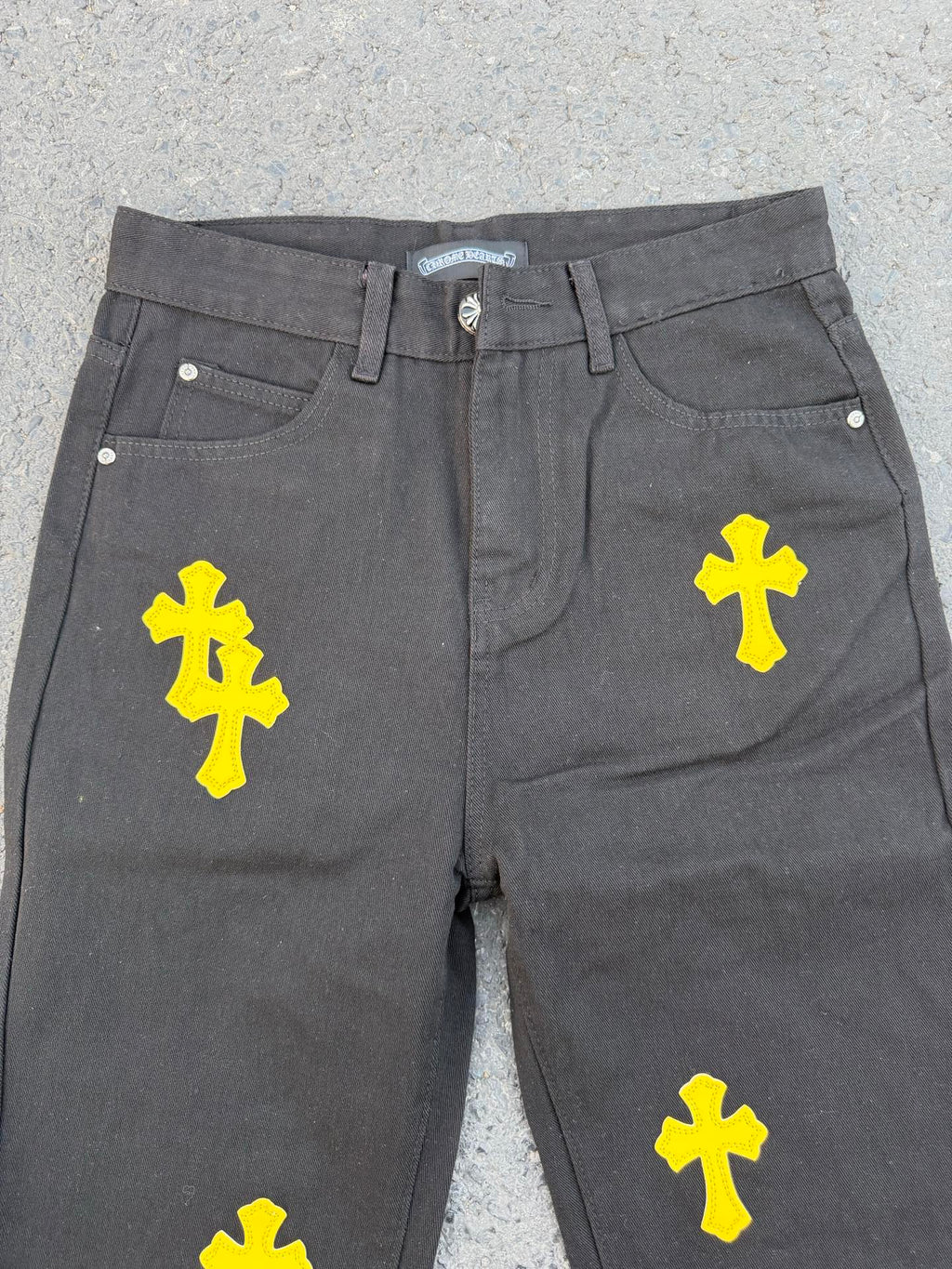Chrome pants in gray fabric with yellow cross graphic prints on the front