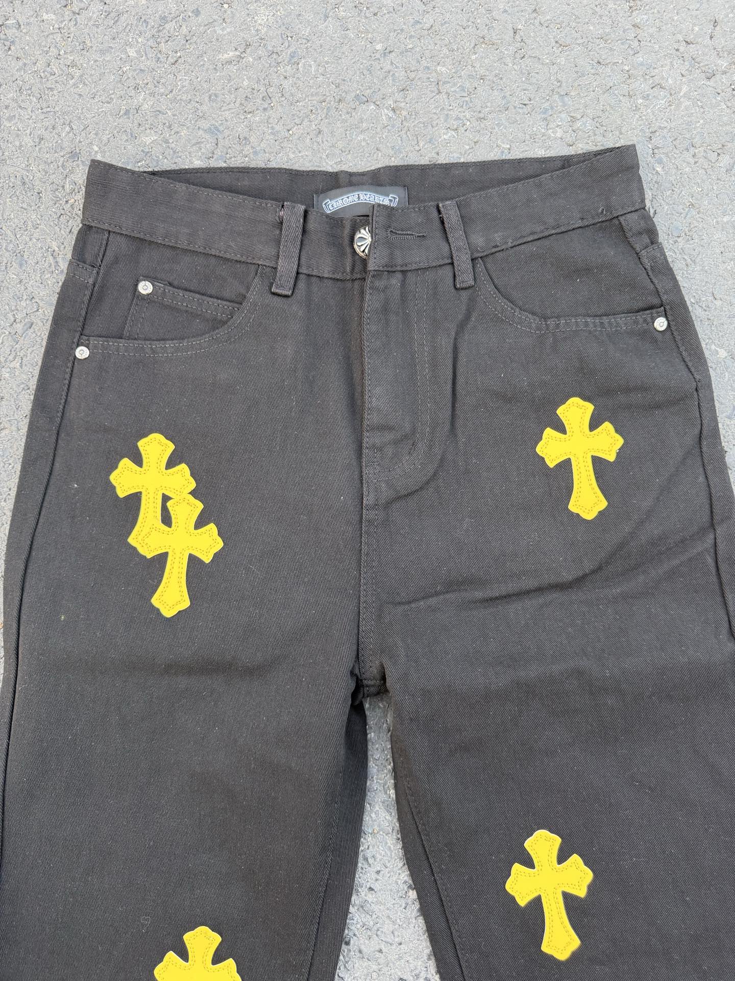 Chrome pants in gray fabric with yellow cross graphic prints on the front
