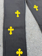 Black pants with yellow cross patches on the front leg