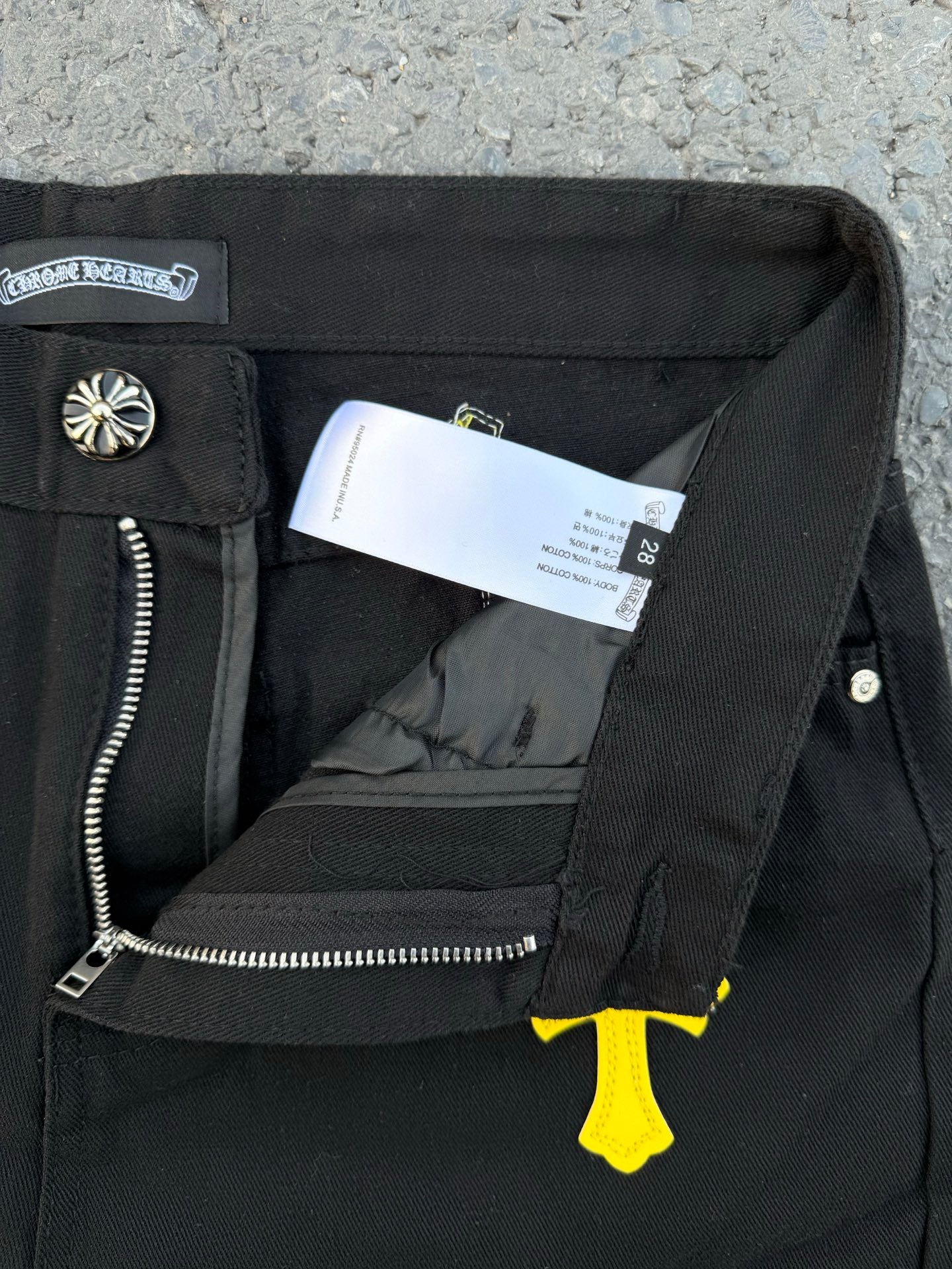 Chrome pants front interior view with zipper fly and printed care tag