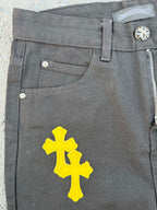 Chrome pants front pocket area in gray with a large yellow cross graphic