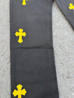 Black pants with yellow cross patches on the upper leg