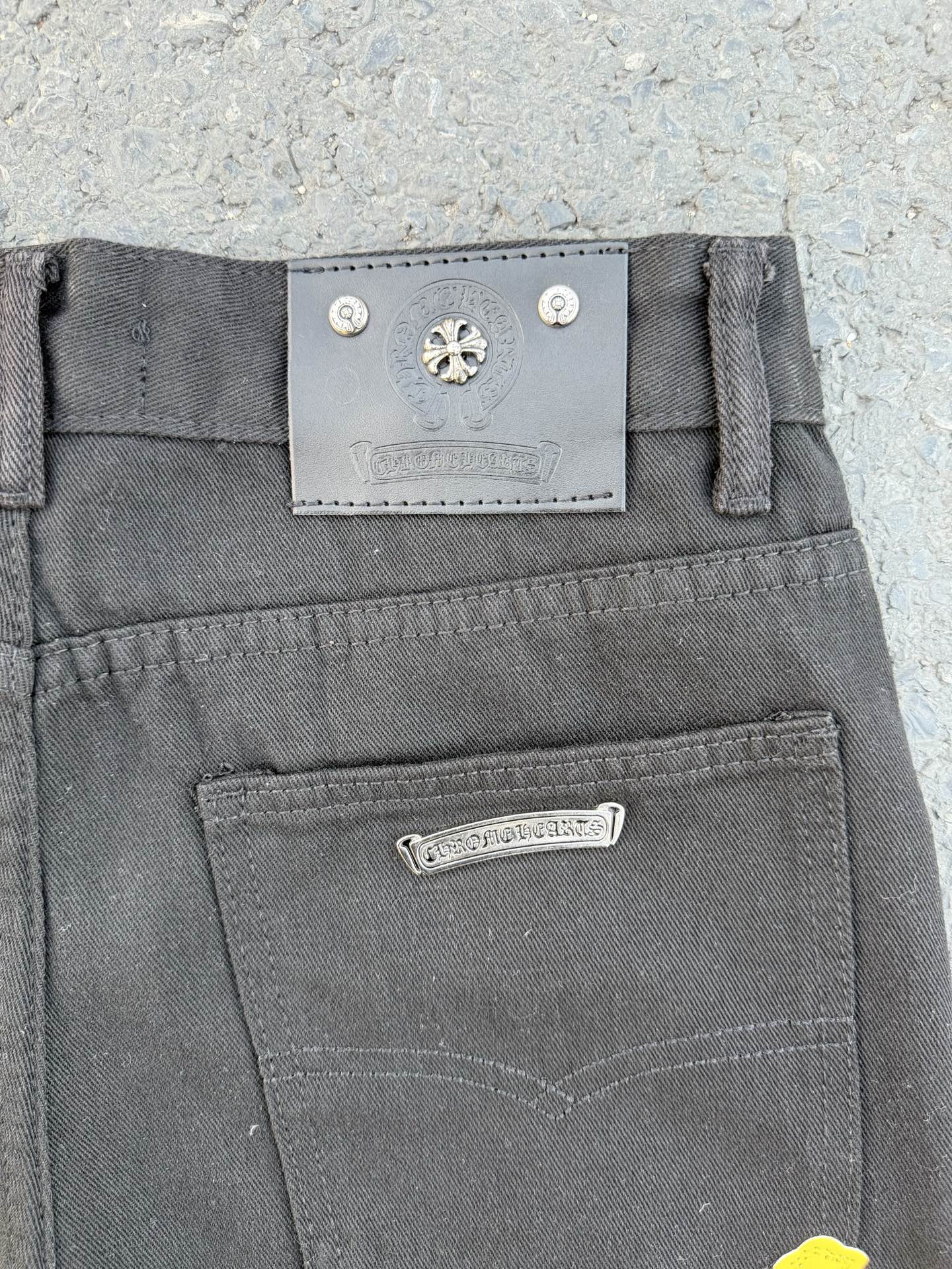 Chrome pants waist label and front closure in gray with metal button detail