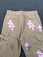 Beige pants back with large embroidered cross patches on pockets