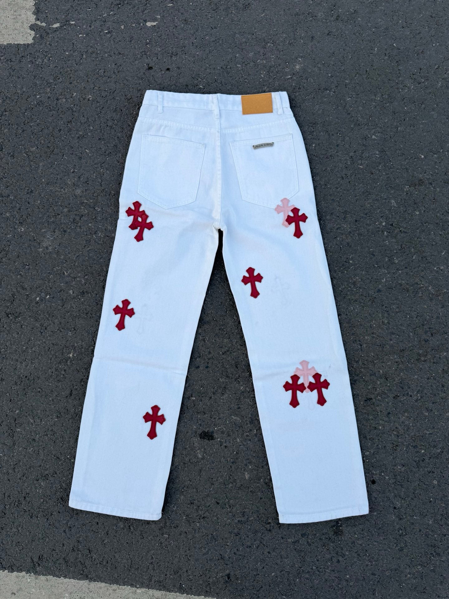 Light blue pants with red cross and grayish cross prints, front view