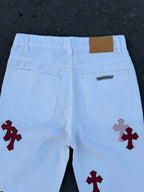 Light blue pants with red cross prints on lower front, pockets and belt loops visible