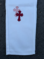 Light blue pants with multicolor cross applique on the leg