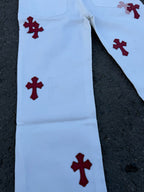 Light blue pants with scattered red cross prints on one side leg