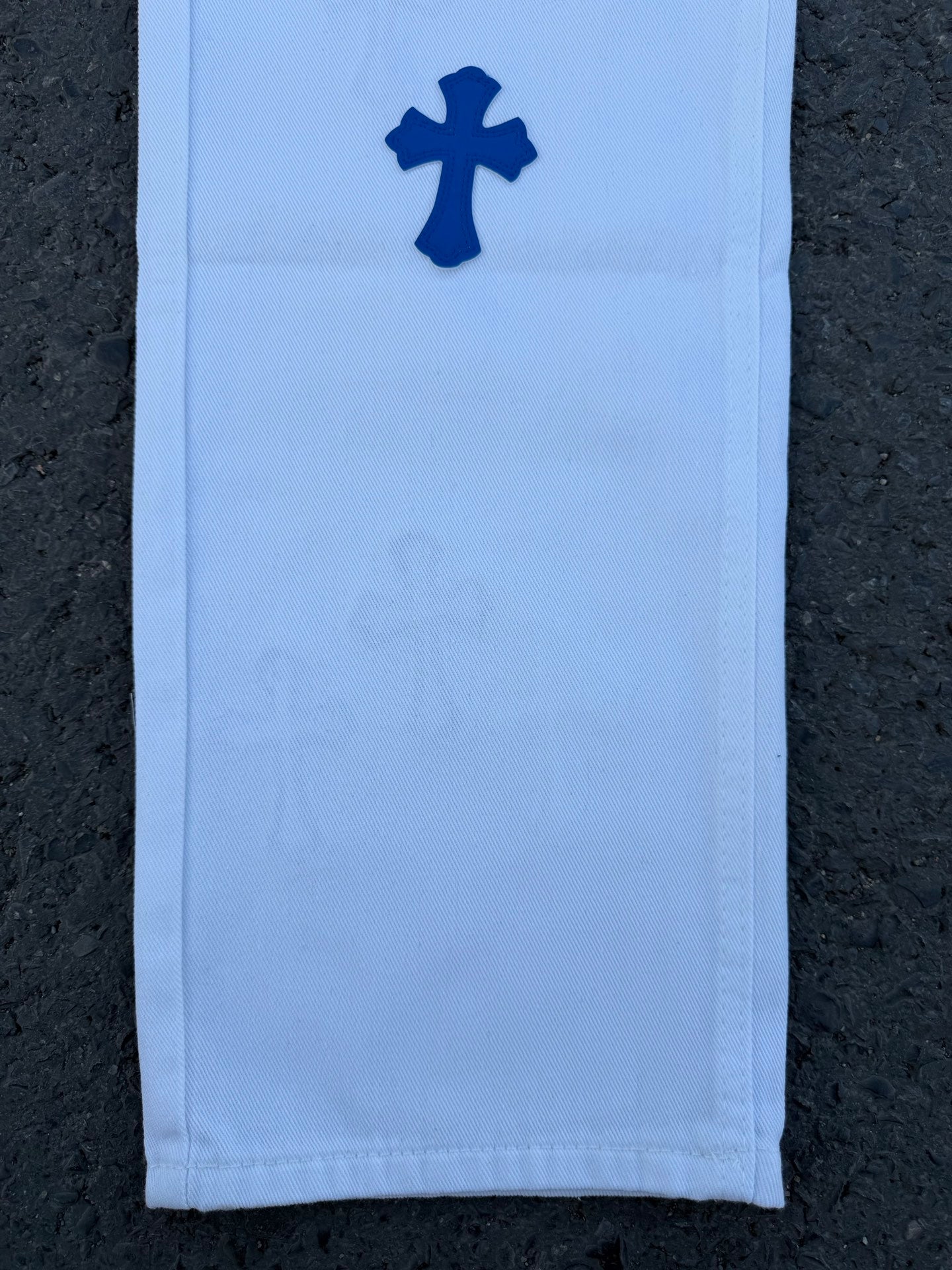 Light blue pants with dark blue cross logo on leg