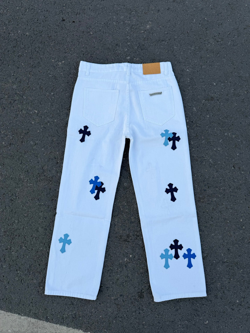 Light blue pants with navy cross print and back welt pockets