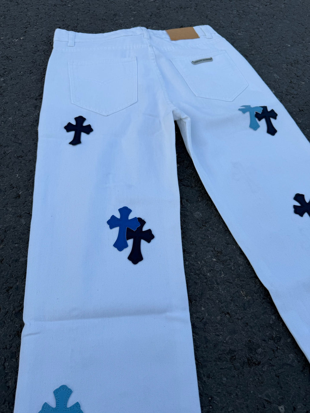 Light blue pants with dark blue cross pattern, front pockets and waistband detail