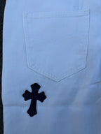 Light blue pants with navy cross print, back pocket close-up
