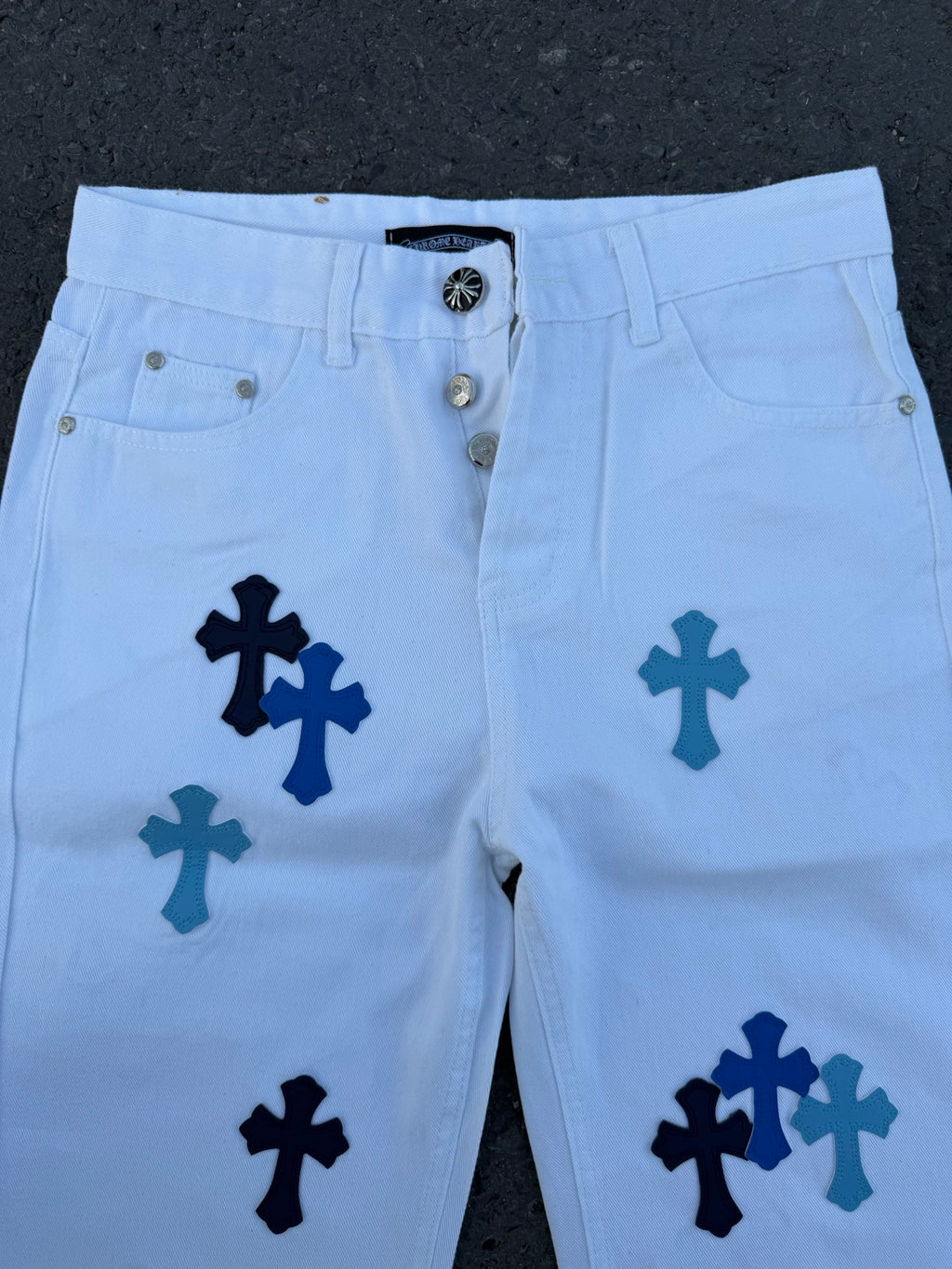 Light blue pants with navy cross print, close-up of front