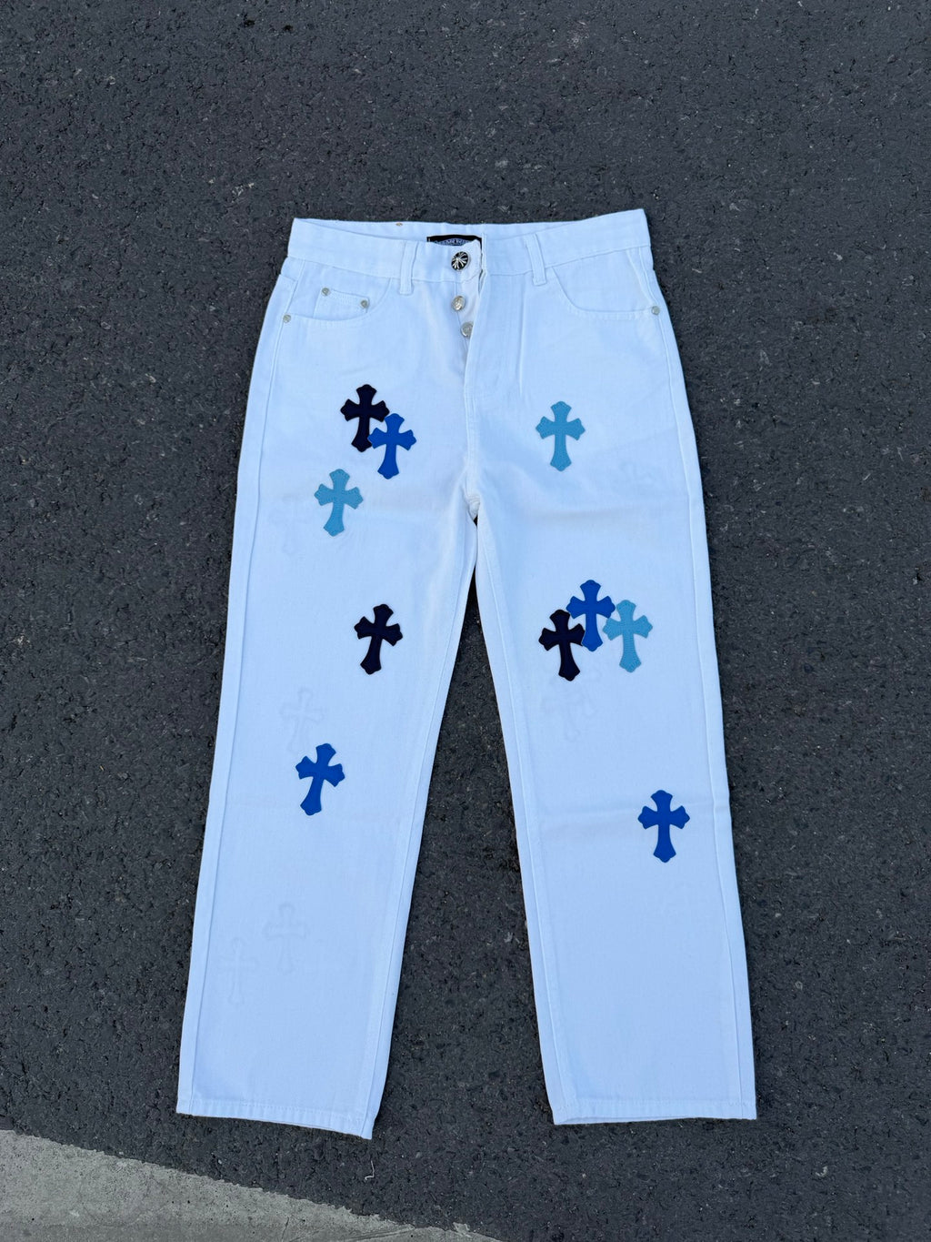 Light blue pants with navy cross print, front view, button fly