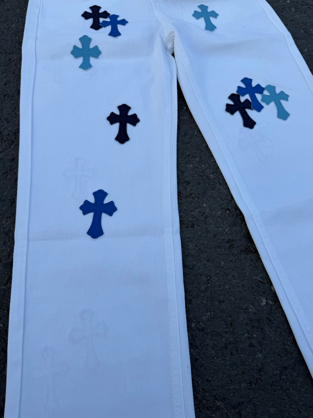 Light blue pants with navy cross print, side view of legs