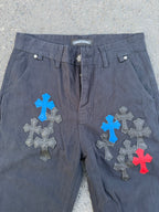 Dark gray pants with front fly and large blue, gray, and red cross patches