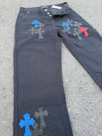 Dark gray pants angled view with front button and colorful cross applique accents