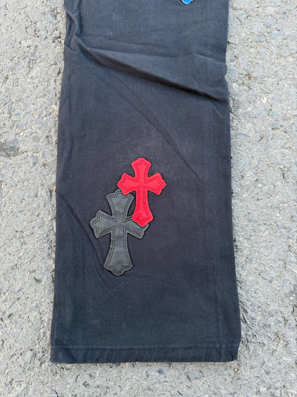 Denim pants with red and gray cross appliques on front