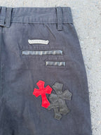 Dark gray pants back close-up with embroidered cross patch and two horizontal pockets