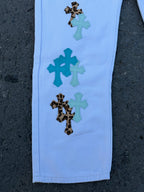 Light blue pants with teal and black patterned appliqué stars and flowers