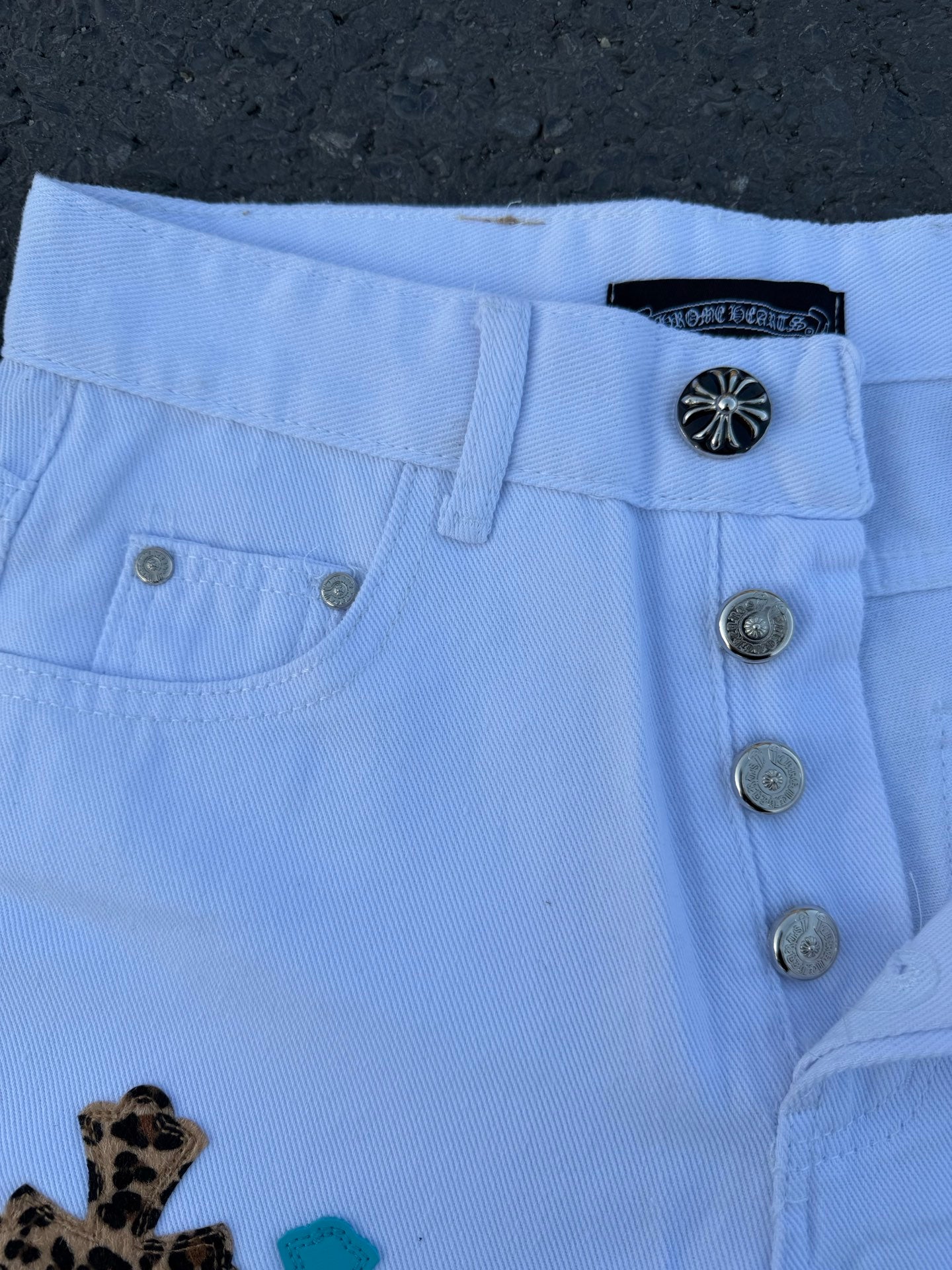 Light blue pants waistband with button closure and metal buttons