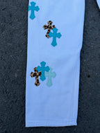 Light blue pants leg with scattered teal and dark spotted appliqué patches