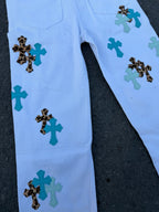 Light blue pants with cross appliques across the front leg panels
